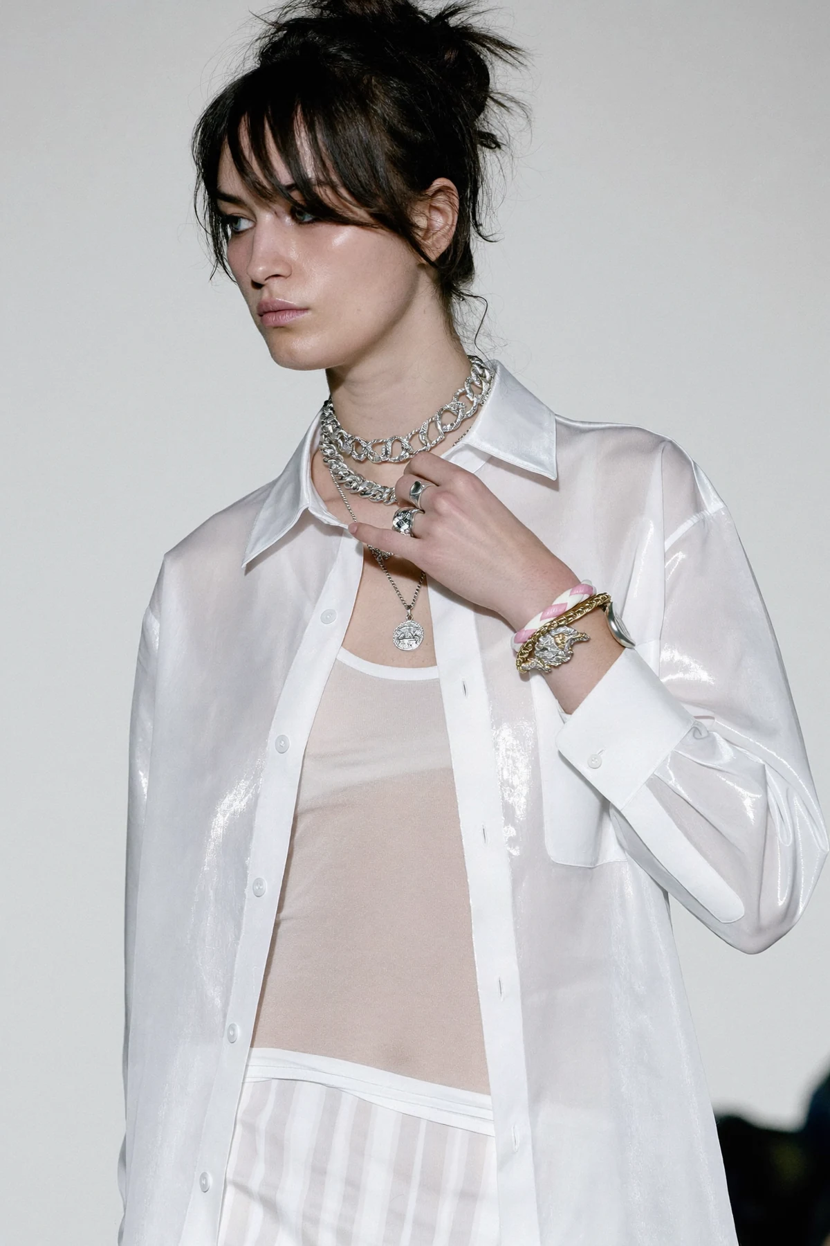Sheer white shirt styled with statement silver jewellery